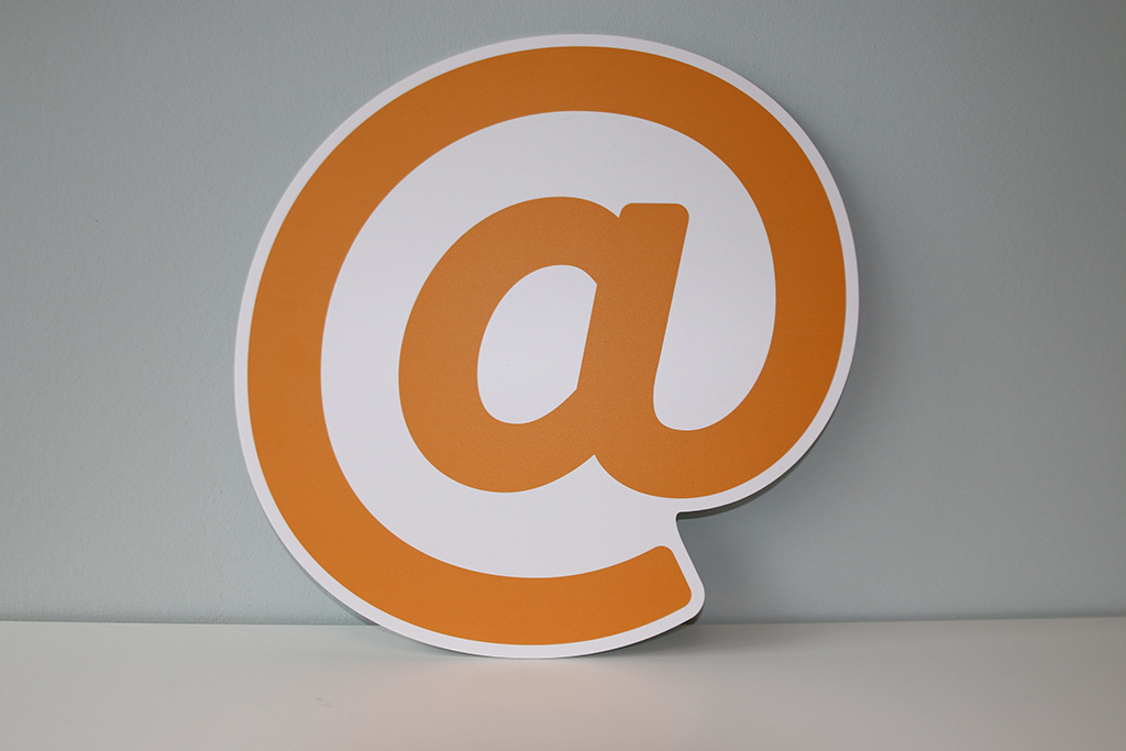 A huge "at sign" in pastel orange color and white stroke | Email marketing strategies from Shizzle Marketing's experts