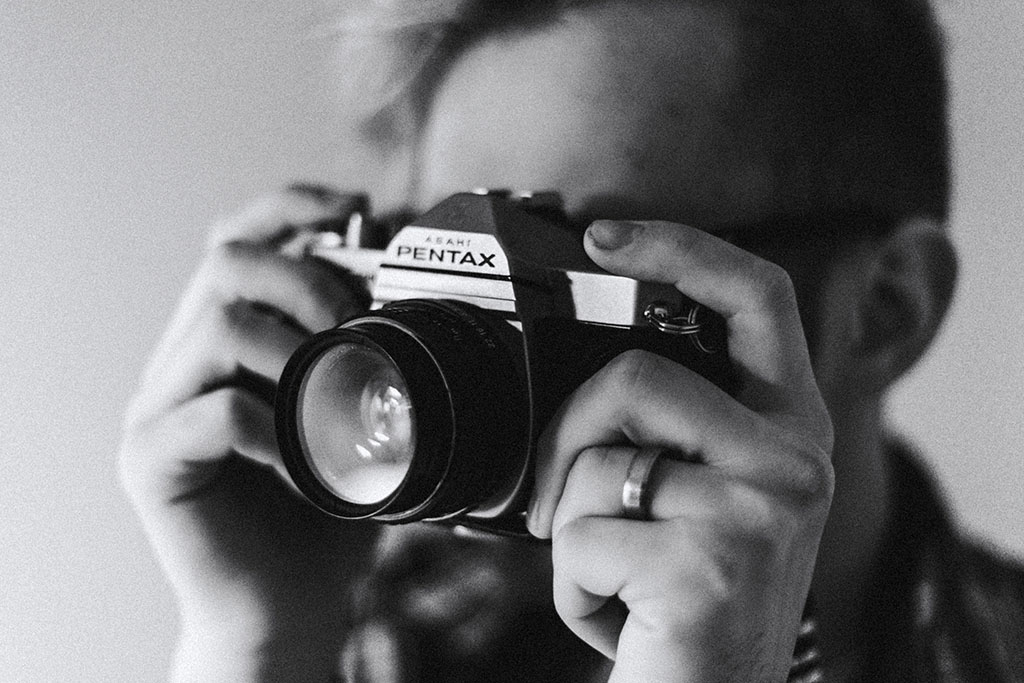 A person holding an old Pentax camera while taking a picture | Majority are visual learners